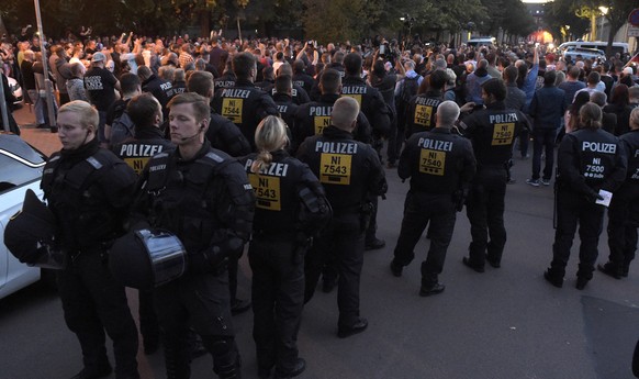 Police secure a demonstration in Koethen, 90 miles southwest of the German capital Berlin, Sunday, Sept. 9, 2018, after police has arrested two Afghan men after a 22-year-old German man died after bra ...