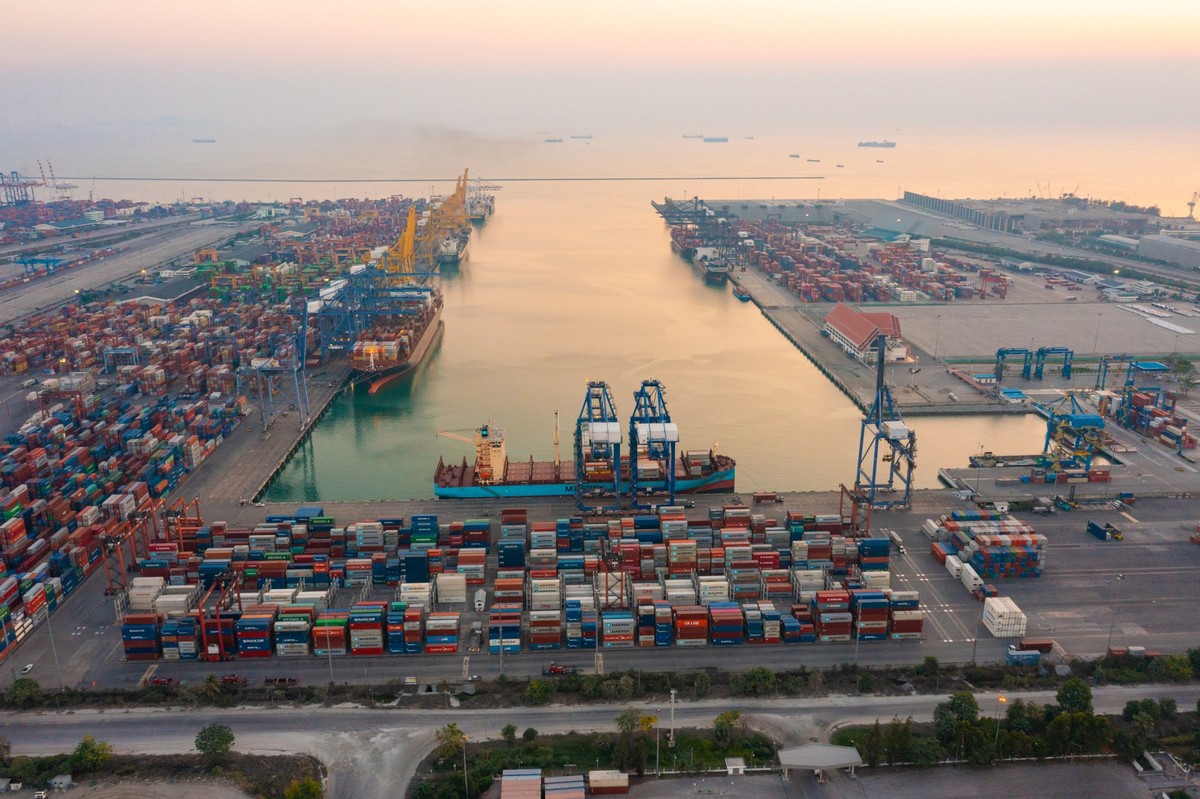 Aerial top view of container cargo ship in the export and import business and logistics international goods in urban city. Shipping to the harbor by crane in Laem Chabang, Chon Buri, Thailand