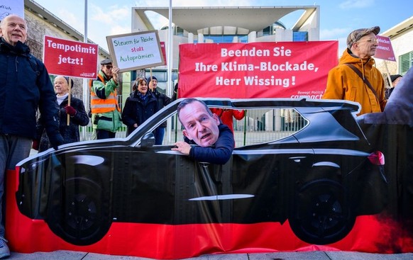 An environmental activist wearing a mask of German Transport Minister Volker Wissing sits in a cut-out car polluting planet earth, during a protest against Wissing&#039;s policies on the sidelines of  ...