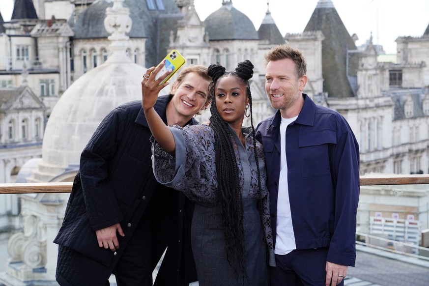 Actress Moses Ingram, center, takes a selfie with actors Hayden Christensen, left, and Ewan McGregor during the photocall for the Disney+ series Obi-Wan Kenobi, at the Corinthia Hotel in London, Thurs ...