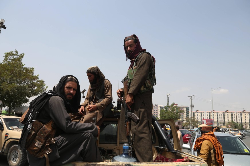 210817 -- KABUL, Aug. 17, 2021 -- Taliban fighters are seen on a military vehicle in Kabul, capital of Afghanistan, Aug. 17, 2021. Normality has returned to Kabul, capital of Afghanistan as the Taliba ...