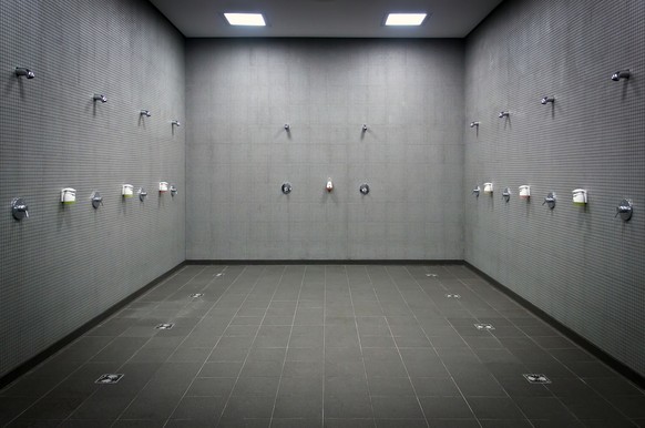 Stock photo of a tiled showers/sauna.