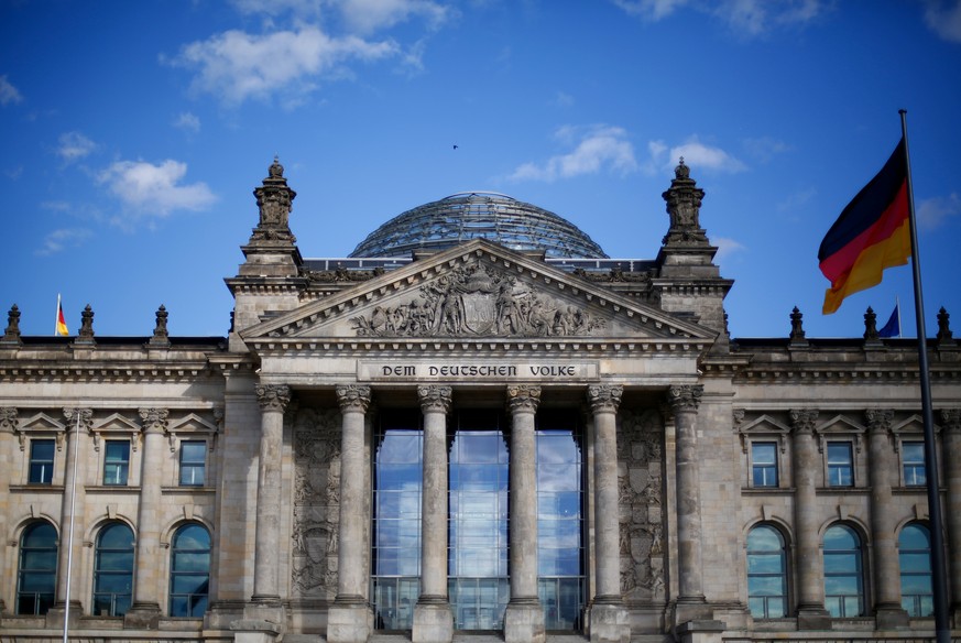 A German flag flutters in front of the Reichstag building in Berlin, Germany, September 6, 2020. Letters read &quot;To the German people&quot;. Picture taken September 6, 2020. REUTERS/Joachim Herrman ...