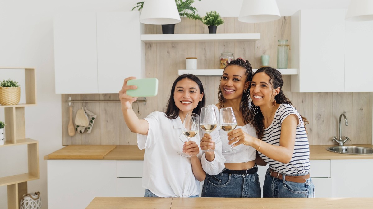 IMAGO Creative, Lifestyle, Leben in einer Wohngemeinschaft, WG Happy friends talking selfie with wineglasses in kitchen model released, Symbolfoto property released, MEUF08058