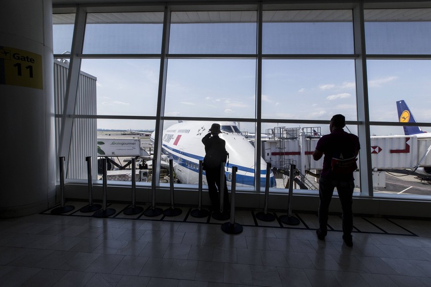 June 10, 2017 - New York, New York, USA - Passengers look out at an Air China Boeing 747 as they wait for their flights in Terminal 1 at JFK International Airport in New York on June 10th, 2017. New Y ...
