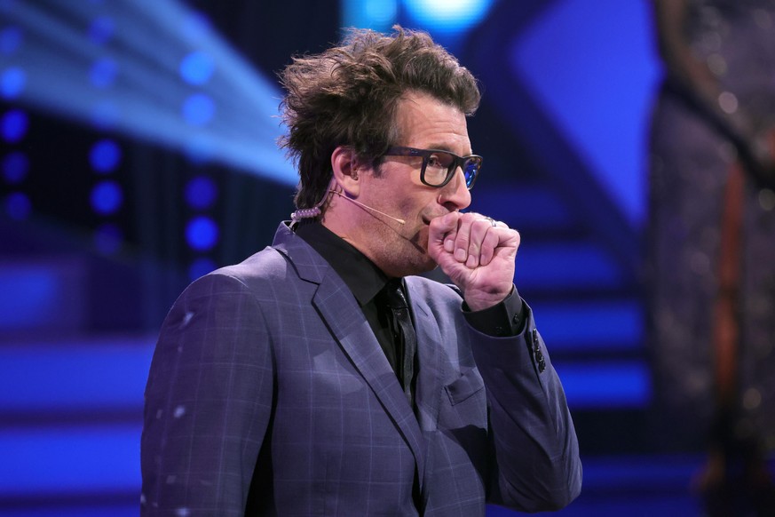 COLOGNE, GERMANY - MAY 14: Host Daniel Hartwich coughs during the 10th show of the 14th season of the television competition &quot;Let&#039;s Dance&quot; on May 14, 2021 in Cologne, Germany. (Photo by ...