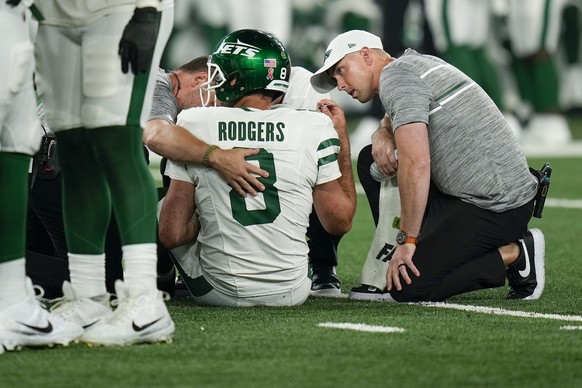 New York Jets quarterback Aaron Rodgers (8) is tended to on the field during the first quarter of an NFL football game against the Buffalo Bills, Monday, Sept. 11, 2023, in East Rutherford, N.J. (AP P ...