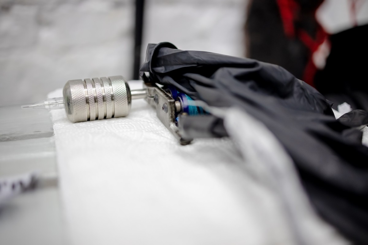 Tattoo machine at body art salon on the table. tattoo equipment with supplies for drawing.selective focus.