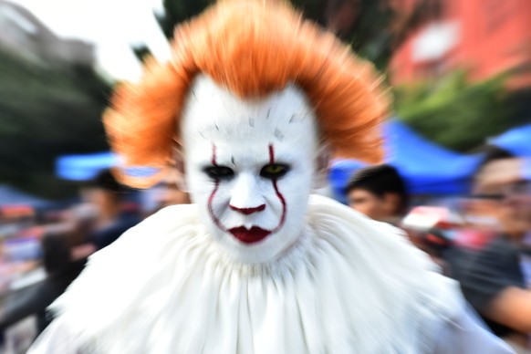 Annual Zombie Walk in Mexico City MEXICO CITY, MEXICO - OCTOBER 19: A man disguised as Pennywise IT is seen taking part during the march of annual Zombie Walk at Monumento of Revolucion on October 19, ...