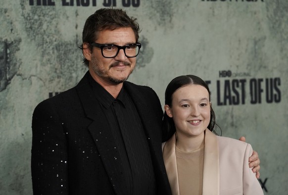 Pedro Pascal, left, and Bella Ramsey, cast members in &quot;The Last of Us,&quot; pose together at the premiere of the HBO series, Monday, Jan. 9, 2023, at the Regency Village Theatre in Los Angeles.  ...