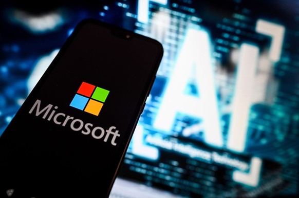 POLAND - 2023/10/03: In this photo illustration, a Microsoft logo is displayed on a smartphone with Artificial intelligence (AI) symbols on the background. (Photo Illustration by Omar Marques/SOPA Ima ...