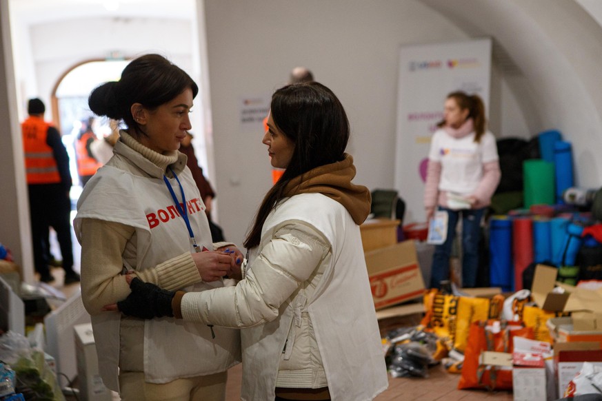 UZHHOROD, UKRAINE - FEBRUARY 28, 2022 - Volunteers sort things at a humanitarian aid collection point for refugees who fled their hometowns because of the Russian invasion, Uzhhorod, western Ukraine,  ...