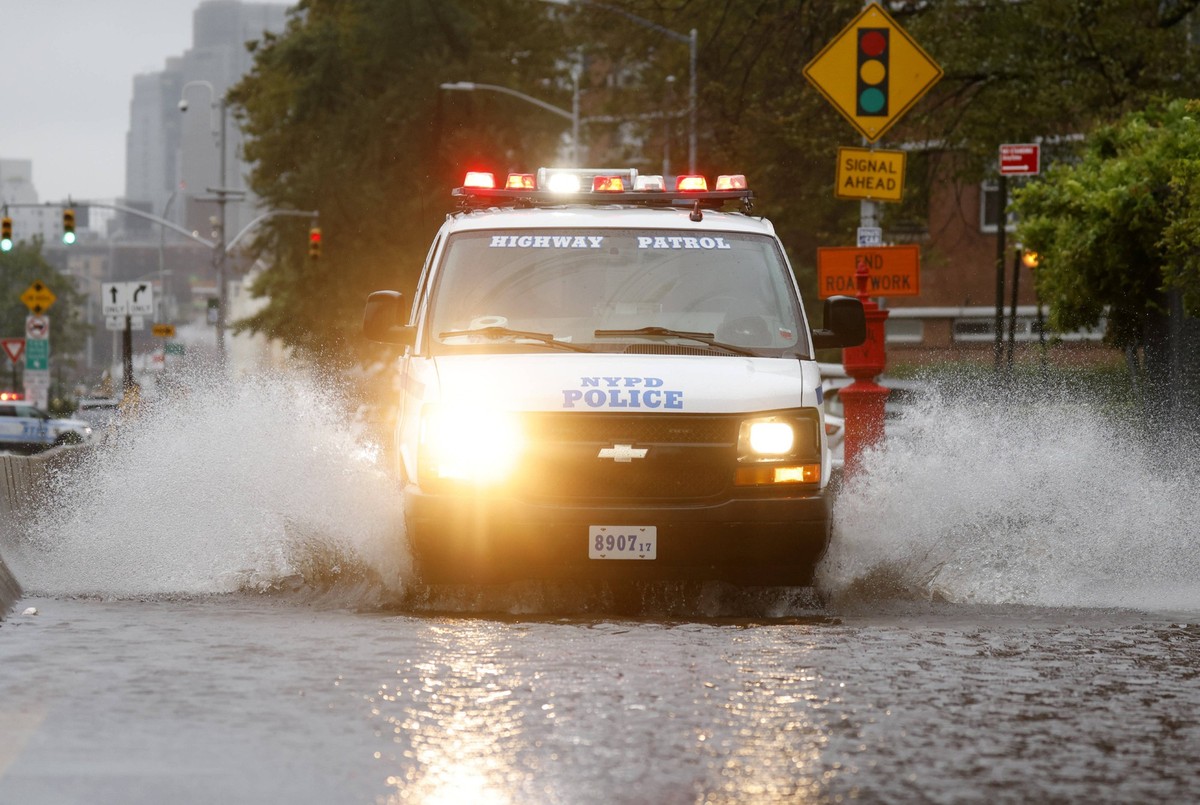 An NYPD Police vehicle crosses a flooded road along the FDR Drive in lower Manhattan during a rain storm in New York City on Friday, September 29, 2023. New York City in state of emergency as torrenti ...