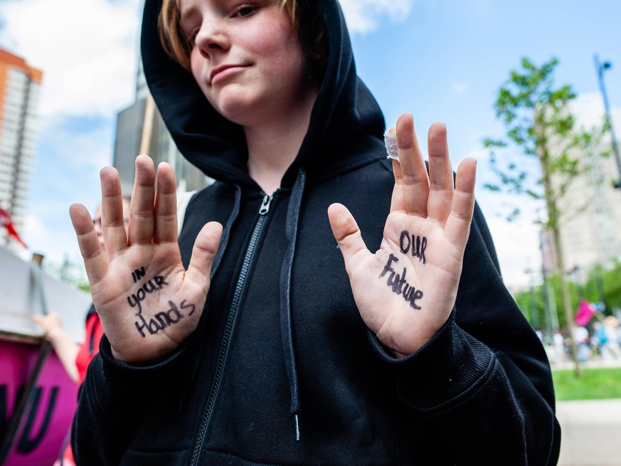 Extinction Rebellion Against Fossil Industry Held A Demonstration In Rotterdam A boy has the message In your hands, our future , written on his hands, during the demonstration organized by XR against  ...