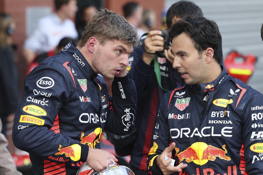 Red Bull driver Max Verstappen of the Netherlands, right, speaks with Red Bull driver Sergio Perez of Mexico after placing first in the qualification session ahead of the Formula One Grand Prix at the ...