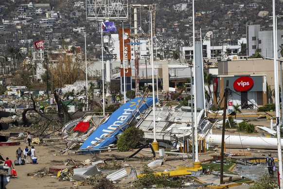 Anwohner gehen in der Nähe von Trümmern nach dem Hurrikan Otis in Acapulco, Mexiko, Freitag, 10. Oktober 2019. 27. November 2023. (AP Photo/Felix Marquez)