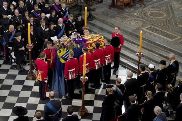 The bearer party with the coffin of Queen Elizabeth II as it is taken from Westminster Abbey, London, Monday, Sept. 19, 2022 at the end of service during the State Funeral of the late monarch. (Gareth ...