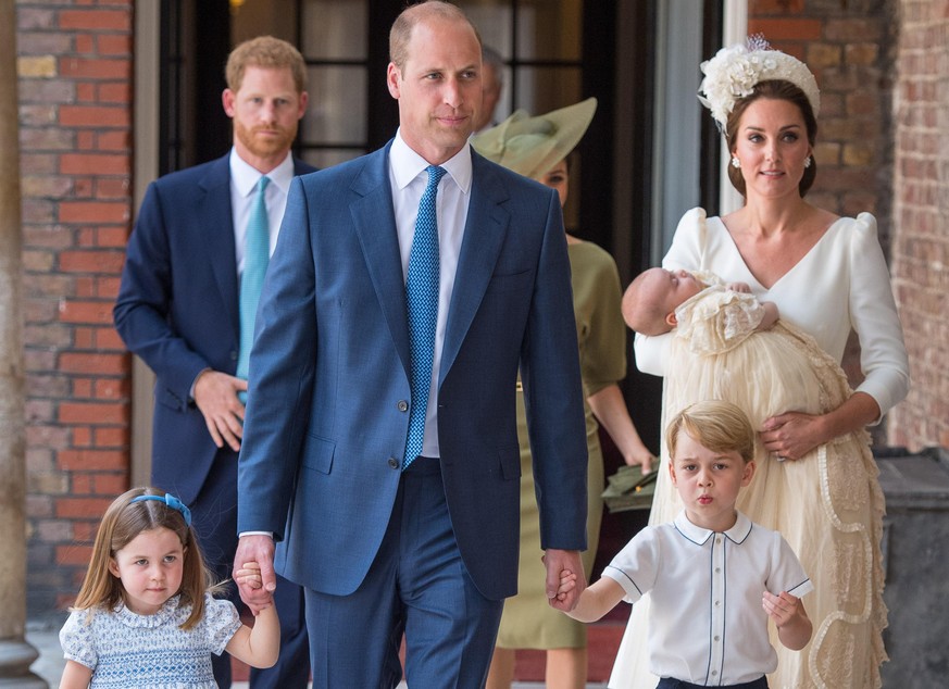 LONDON, ENGLAND - JULY 09: Princess Charlotte and Prince George hold the hands of their father, Prince William, Duke of Cambridge, as they arrive at the Chapel Royal, St James's Palace, London for the ...