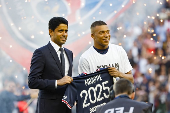 220522 -- PARIS, May 22, 2022 -- Paris Saint-Germain s French forward Kylian Mbappe R poses with PSG president Nasser Al-Khelaifi after the announcement Kylian Mbappe staying at PSG until 2025, before ...