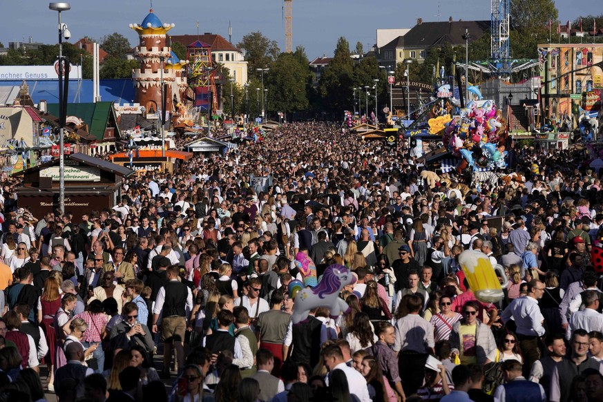 People enjoy a sunny Sunday at the 188th Oktoberfest beer festival in Munich, Germany, Oct. 1, 2023. (AP Photo/Matthias Schrader)