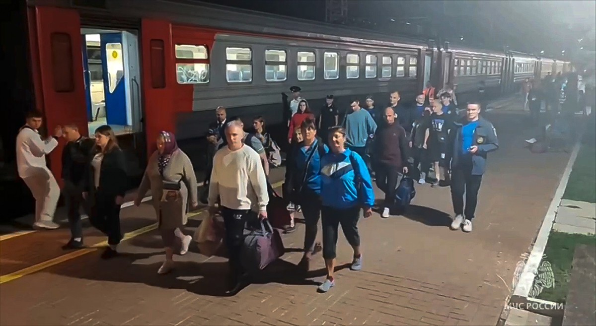 In this photo released by Russian Emergency Ministry Press Service on Friday, Aug. 9, 2024, residents from the Kursk region arrive in railway station in Tula were they were met by employees of the Rus ...
