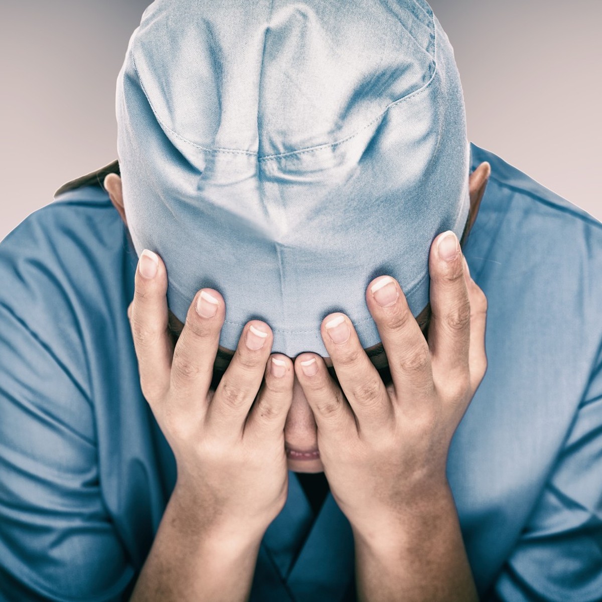 Crying doctor during COVID-19 needing help in hospital. Healthcare workers in despair over emergency need of PPE and distress. Coronavirus crisis death, despair, mental health anxiety.