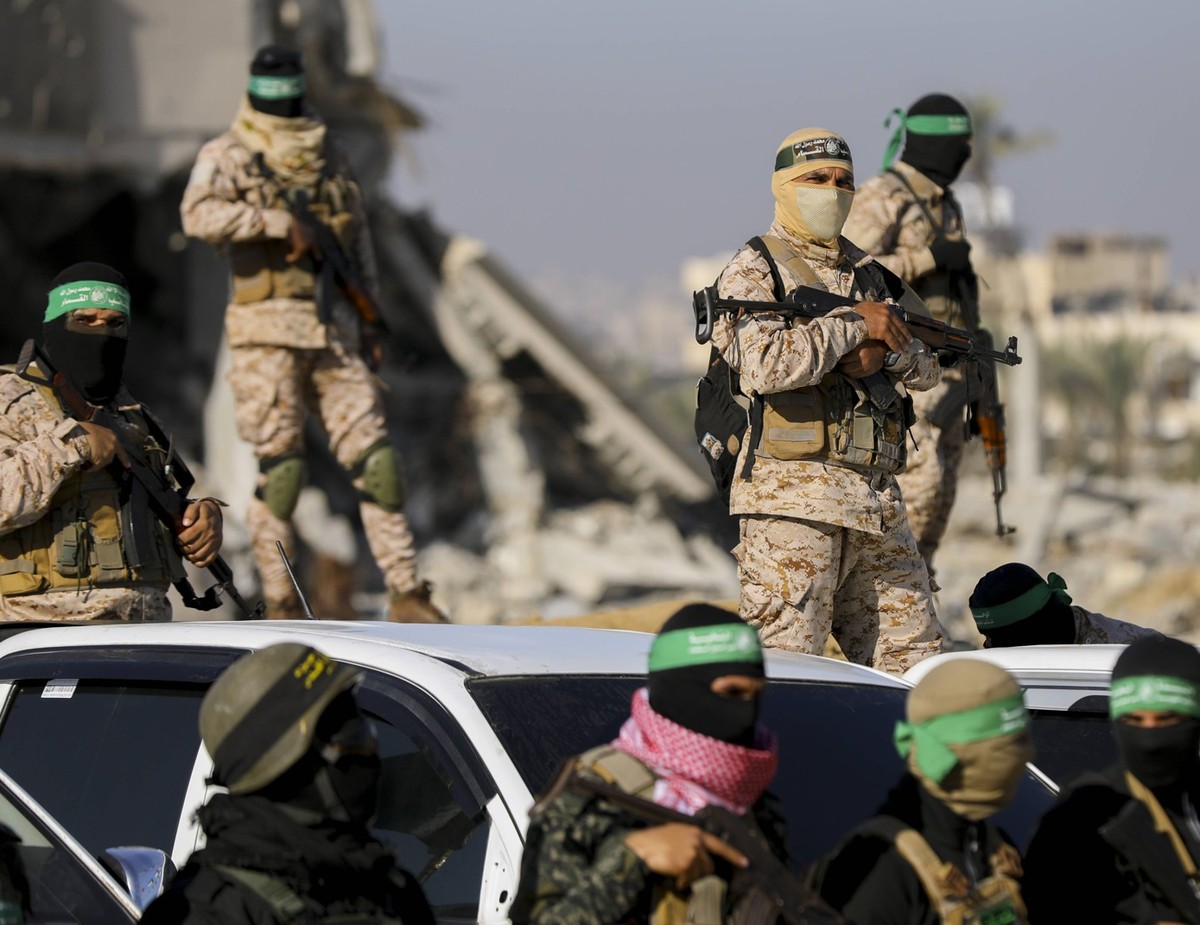 Hamas Transfers Hostages Armed militants stand near the main exchange site as preparations continue in Gaza on February 15, 2025. Militants are set to release three Israeli hostages as part of a priso ...