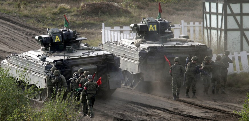 FILE -- Soldiers follow a Marder infantry fighting vehicle during a demonstration event held for the media by the German Bundeswehr in Bergen near Hannover, Germany, Wednesday, Sept. 28, 2011. U.S. Pr ...