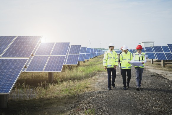 Asian engineers survey at green energy base