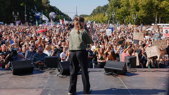 German climate activist Luisa Neubauer speaks on stage during a protest of the Fridays for Future movement and other activists at the Brandenburg Gate in Berlin on September 15, 2023. (Photo by Odd AN ...