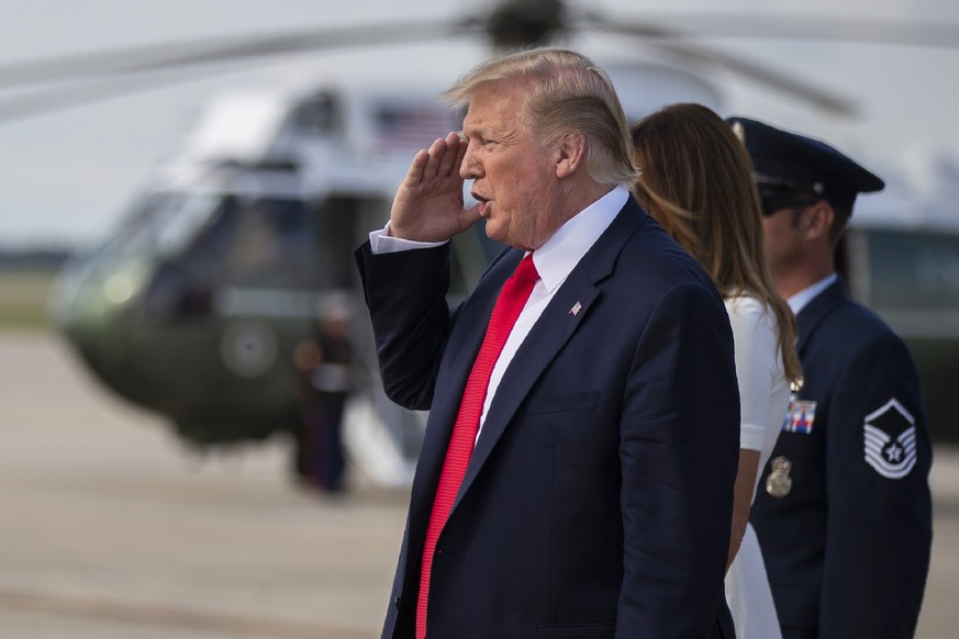 President Donald Trump, with first lady Melania Trump, salutes upon arrival at Andrews Air Force Base, Md., Sunday, July 7, 2019. (AP Photo/Manuel Balce Ceneta)