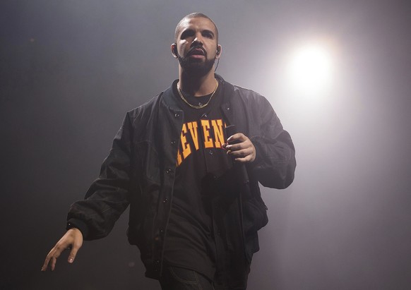 FILE - Drake performs during a concert as part of the Summer Sixteen Tour in New York, Aug. 5, 2016. Some audience members leaving a concert by Drake at a Manhattan theater came outside to see a New Y ...