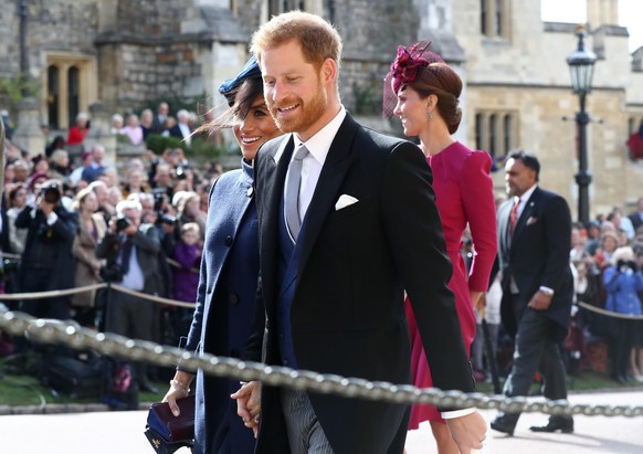WINDSOR, ENGLAND - OCTOBER 12: Meghan, The Duchess of Sussex and Prince Harry, the Duke of Sussex after the wedding of Princess Eugenie to Jack Brooksbank at St George's Chapel in Windsor Castle ...