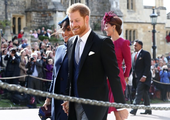 WINDSOR, ENGLAND - OCTOBER 12: Meghan, The Duchess of Sussex and Prince Harry, the Duke of Sussex after the wedding of Princess Eugenie to Jack Brooksbank at St George&#039;s Chapel in Windsor Castle  ...