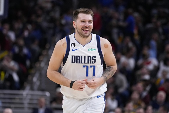 Dallas Mavericks guard Luka Doncic (77) smiles after a basket against the Indiana Pacers during the second half of an NBA basketball game in Indianapolis, Monday, March 27, 2023. The Mavericks defeate ...