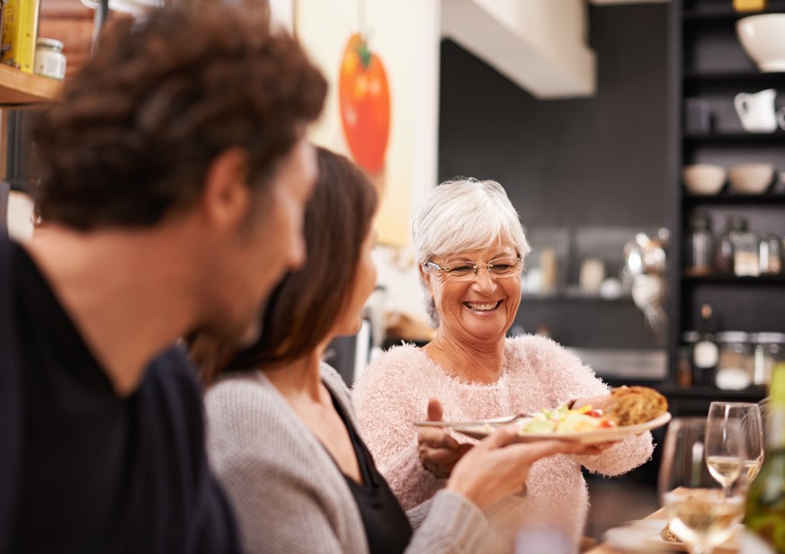 Shot of a family sitting down to dinner together