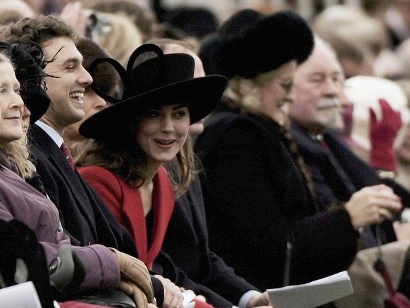 SANDHURST, ENGLAND - DECEMBER 15: HRH Prince William's girlfriend Kate Middleton (C) smiles while watching William take part in The Sovereign's Parade at The Royal Military Academy Sandhurst on Decemb ...