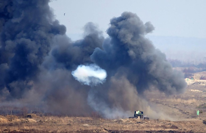 Ukrainian President Volodymyr Zelensky (not shown) watches Ukrainian troops take part in a military drill outside the city of Rivne, northern Ukraine on Wednesday on February 16, 2022. Photo by Ukrain ...