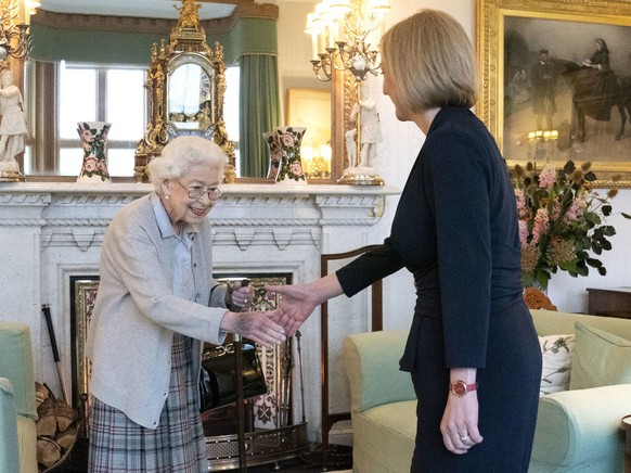 Britain's Queen Elizabeth II, left, welcomes Liz Truss during an audience at Balmoral, Scotland, where she invited the newly elected leader of the Conservative party to become Prime Minister and form  ...