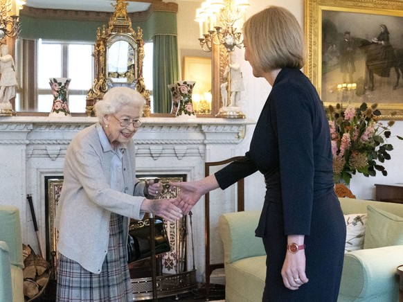 Britain's Queen Elizabeth II, left, welcomes Liz Truss during an audience at Balmoral, Scotland, where she invited the newly elected leader of the Conservative party to become Prime Minister and form ...