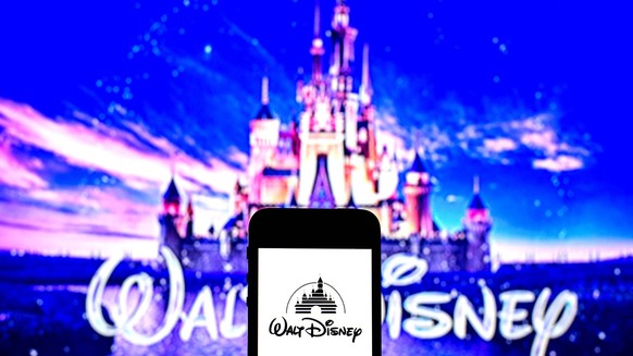 August 3, 2021, Barcelona, Catalonia, Spain: In this photo illustration a Walt Disney Pictures logo seen displayed on a smartphone with a Walt Disney Pictures logo in the background. Barcelona Spain - ...