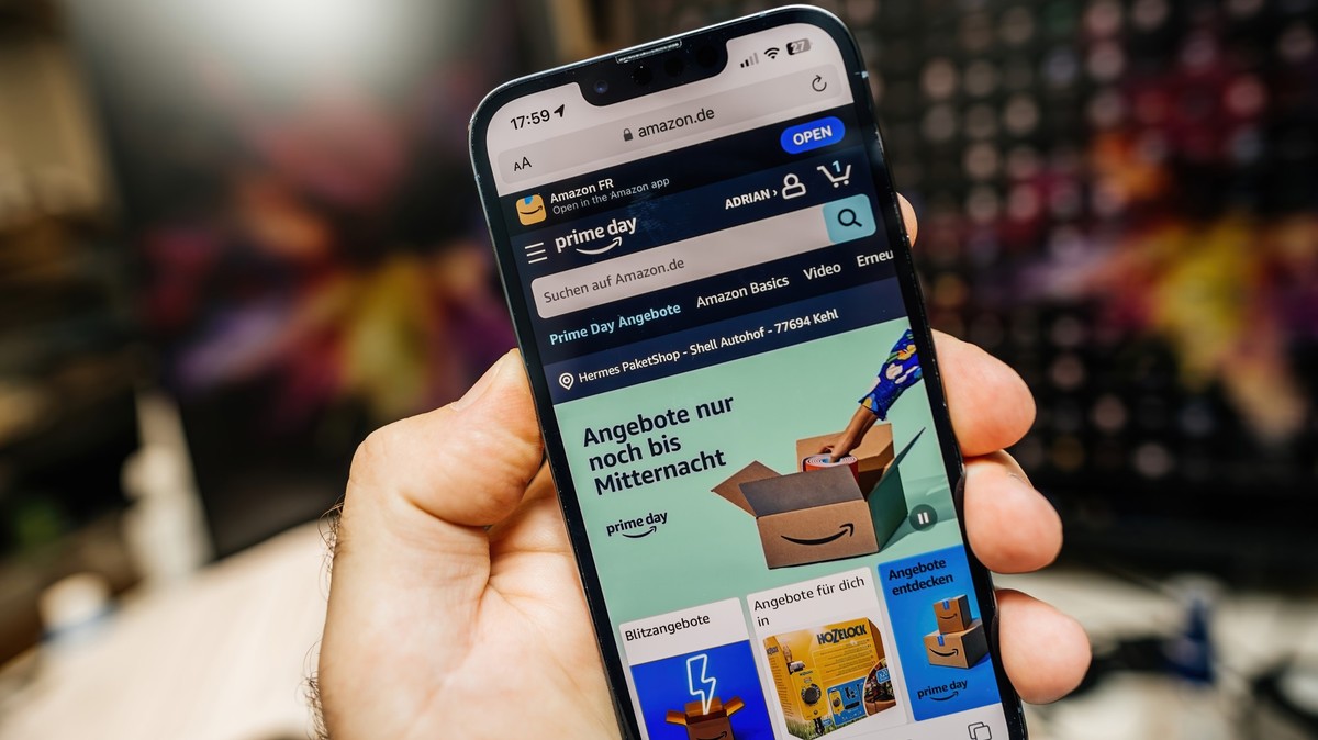 Paris, France - Jul 12, 2023: A male hand holds an Apple iPhone 15 Pro, displaying the German Amazon webpage that invites users to shop during the Prime Day event Model Released Property Released xkwx ...