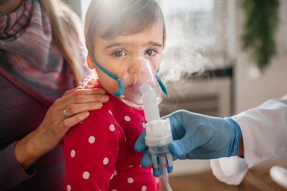 Asthma, little girl with inhaling mask