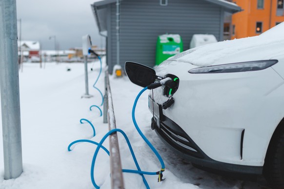 Electric car charging outdoors in the winter.