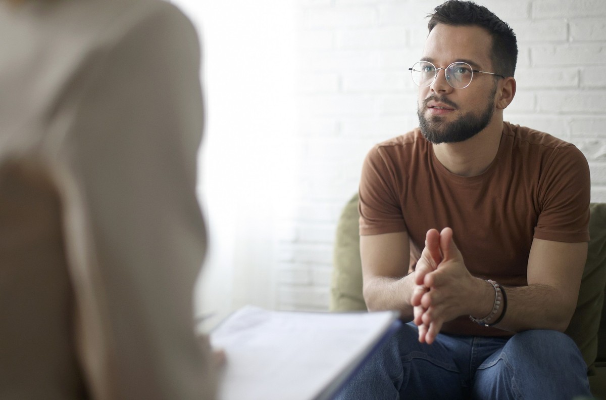 Young man talking to a psychiatrist. About 30 years old, Caucasian male.