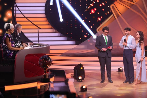 COLOGNE, GERMANY - MARCH 03: Judges Jorge Gonzalez, Motsi Mabuse and Joachim Llambi speak with host Daniel Hartwich and candidates Younes Zarou and Malika Dzumaev on stage during the second &quot;Let& ...