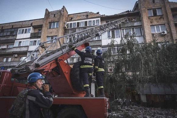 In this photo provided by the Ukrainian Emergency Service, rescuers evacuate people from a damaged building after Russian missile strikes in Pokrovsk, Donetsk region, Ukraine, Monday, Aug. 7, 2023. (U ...