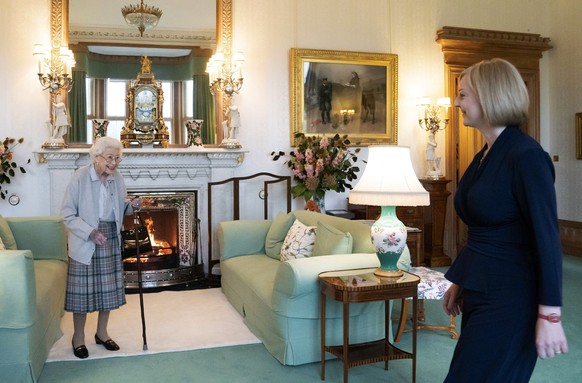 Britain&#039;s Queen Elizabeth II, left, smiles at Liz Truss during an audience at Balmoral, Scotland, where she invited the newly elected leader of the Conservative party to become Prime Minister and ...