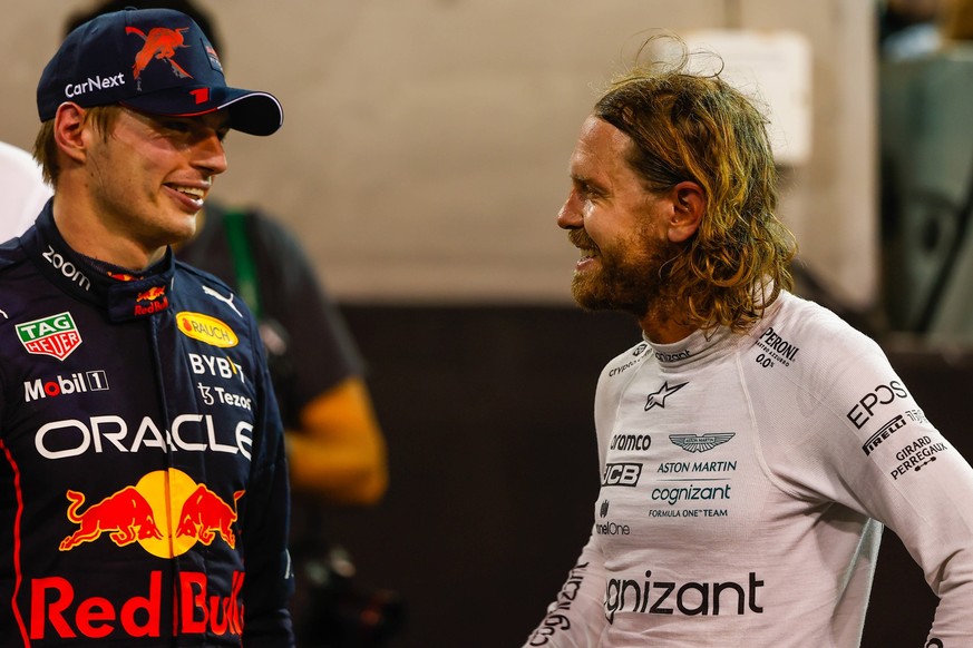Formula 1 2022: Abu Dhabi GP YAS MARINA CIRCUIT, UNITED ARAB EMIRATES - NOVEMBER 20: Max Verstappen, Red Bull Racing, 1st position, and Sebastian Vettel, Aston Martin, talk at the end of the race duri ...