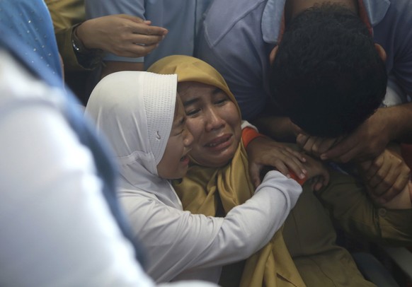 Relatives of passengers comfort each other as they wait for news on a Lion Air plane that crashed off Java Island at Depati Amir Airport in Pangkal Pinang, Indonesia Monday, Oct. 29, 2018. Indonesia d ...